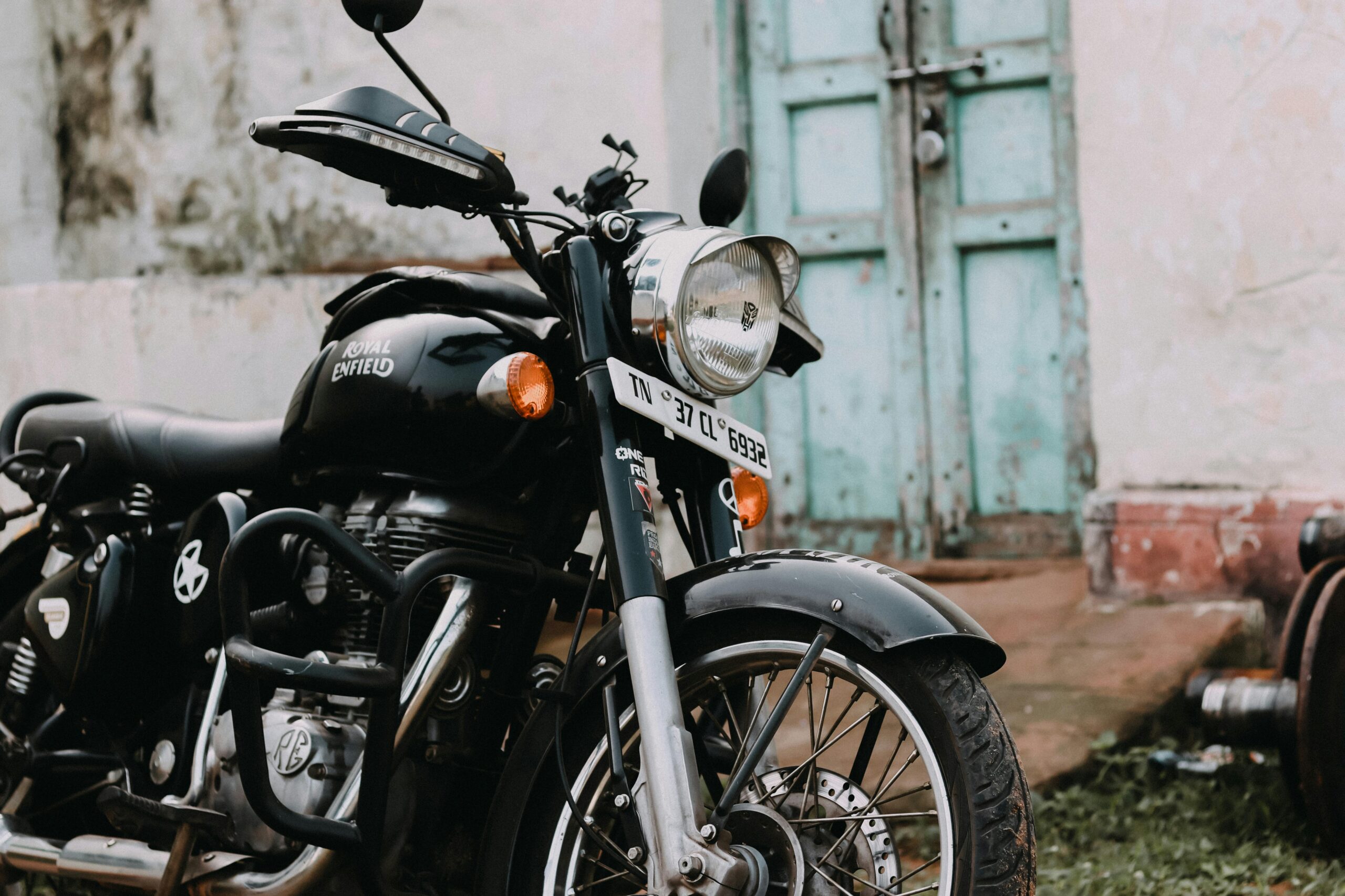 Close-up of a vintage Royal Enfield motorcycle parked outdoors in Coimbatore.